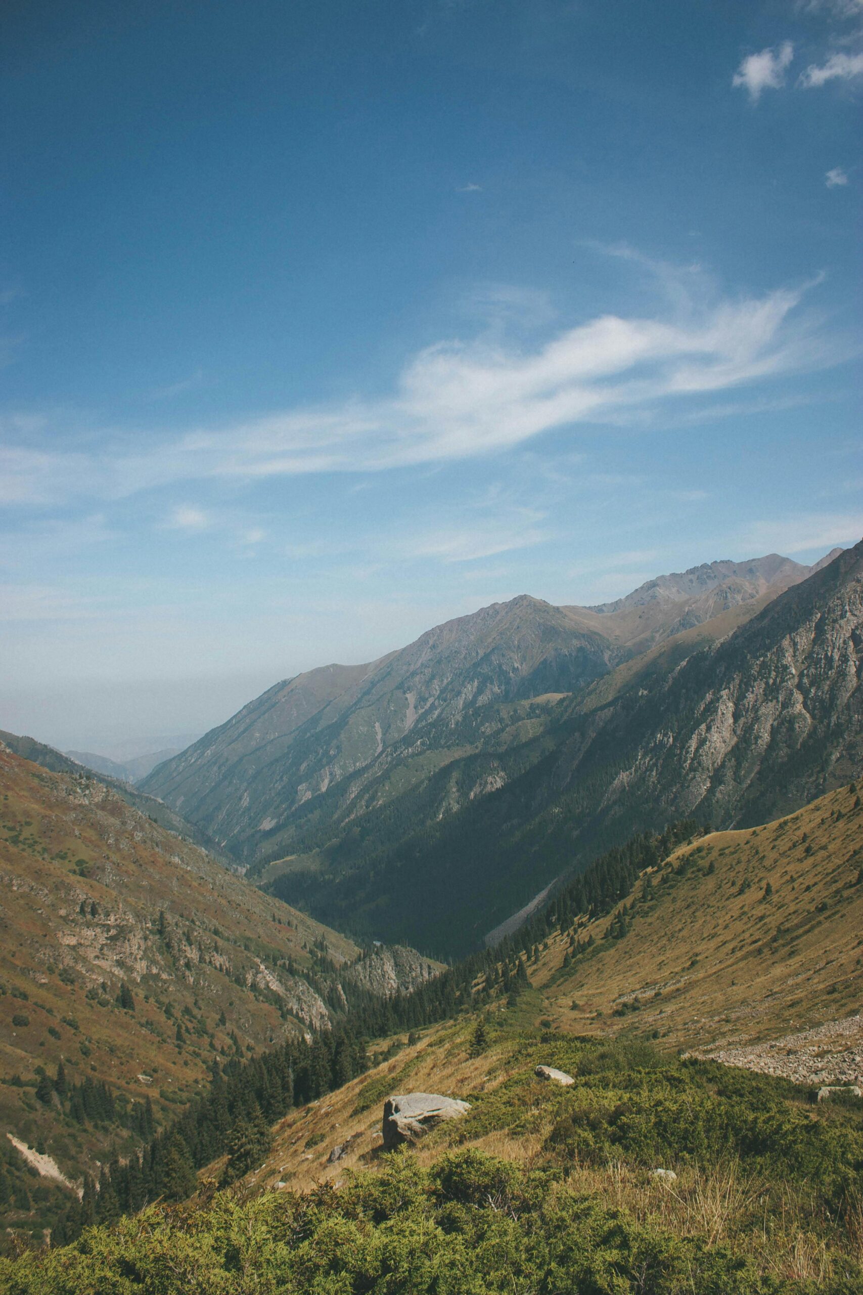 Stunning mountain landscape near Almaty, Kazakhstan with deep valleys and clear blue skies.